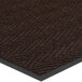 A close-up of a brown Lavex Chevron Rib carpet with black trim.