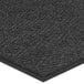 A close-up of a black Lavex carpet mat with a chevron pattern.