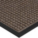 A white indoor entrance mat with a brown waffle pattern and black border.