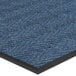 A blue carpet mat with a black border designed with a chevron pattern.