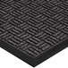 A close-up of a black rubber Lavex parquet entrance mat with a pattern on it.