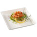 A Solia white square plate with shrimp and lemon.