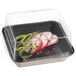 A Solia transparent PET lid on a plastic container with food in it.