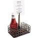 A Front of the House coppered fused iron condiment caddy with a ketchup bottle in a metal holder with a sign.