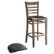 A Lancaster Table & Seating wooden ladder back bar stool with a detached black vinyl seat.