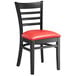 A Lancaster Table & Seating black wood ladder back chair with a red vinyl seat