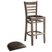 A Lancaster Table & Seating wood ladder back bar stool with a dark brown vinyl seat detached from the chair.