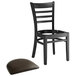 A Lancaster Table & Seating black wood ladder back chair with a detached dark brown vinyl seat