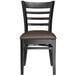 A Lancaster Table & Seating black wood ladder back chair with dark brown vinyl seat on a white background.