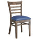 A Lancaster Table & Seating wooden ladder back chair with a navy vinyl cushion.