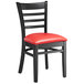 A black wood Lancaster Table & Seating Ladder Back chair with a red vinyl seat.