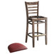 A Lancaster Table & Seating wood ladder back bar stool with a burgundy vinyl seat cushion.