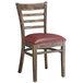 A Lancaster Table & Seating wooden ladder back chair with a burgundy vinyl seat