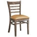 A Lancaster Table & Seating wooden ladder back chair with a light brown vinyl seat.
