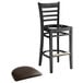 A Lancaster Table & Seating black wood ladder back bar stool with dark brown vinyl seat on a white background.