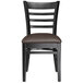 A Lancaster Table & Seating black wood ladder back chair with dark brown vinyl cushion.