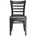 A Lancaster Table & Seating black wood ladder back chair with a black vinyl seat.