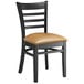 A black Lancaster Table & Seating wood ladder back chair with a light brown vinyl seat.