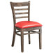 A Lancaster Table & Seating wooden ladder back chair with a red vinyl seat.