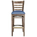 A Lancaster Table & Seating wooden ladder back bar stool with a navy vinyl seat.