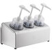 A Steril-Sil stainless steel 3-compartment pump condiment dispenser with white dome top pump lids.