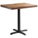 A rectangular wooden table with a black cast iron base.