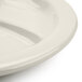A close up of a Tuxton Healthcare 3-compartment China Plate on a white surface.