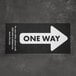 A black E-Z Up rectangle floor decal with a white arrow and white text reading "One Way"