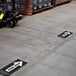 A warehouse floor with E-Z Up black rectangle floor decals.