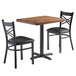 A Lancaster Table & Seating rectangular wood butcher block table with two black cross back chairs.