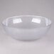 A clear glass bowl with a white rim on a white surface.