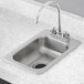 A Regency stainless steel drop-in sink with a faucet.