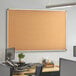 A 72" x 48" Dynamic by 360 Office Furniture wall-mount cork board with an aluminum frame on a wall.