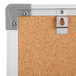 A close-up of a Dynamic by 360 Office Furniture wall-mount cork board with an aluminum frame.