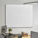 A Dynamic by 360 Office Furniture wall-mounted frosted glass white board.