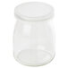 A clear glass jar with a white lid.