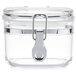 A clear plastic Tablecraft condiment jar with a metal hinge lock closure.