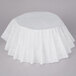 A white tablecloth on a table with a Bunn urn style coffee filter package.