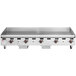 A Wolf stainless steel countertop gas griddle with manual controls over four burners.