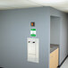 A wall with a door and a green sign for a Guardian recess mounted eye and face wash station.