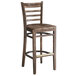 A Lancaster Table & Seating wood ladder back bar stool with a vintage wood seat.