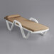 A white and tan Lancaster Table & Seating chaise lounge with beige cushion and pillow.
