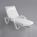 A white Lancaster Table & Seating chaise lounge with a pillow.