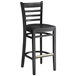 A Lancaster Table & Seating black wood ladder back bar stool with black seat.