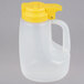 A white plastic Tablecraft dispenser jar with a yellow lid and handle.