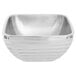 A silver stainless steel square bowl with a curved edge.