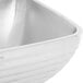 A stainless steel Vollrath square serving bowl with double walls.
