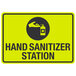 A yellow sign reading "Hand Sanitizer Station" with a hand and hand sanitizer icon.