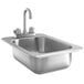 A Regency stainless steel drop-in sink with faucet in a counter.