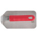 A metal steak weight with a red rectangular silicone handle.